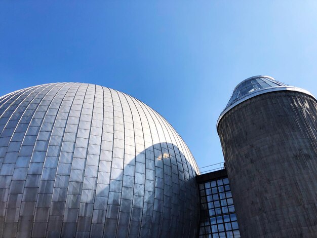 Low angle view of modern building against clear blue sky