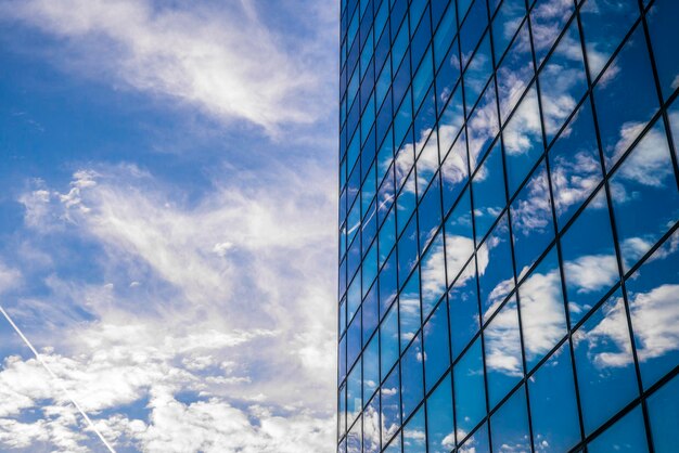 Low angle view of modern building against cloudy sky