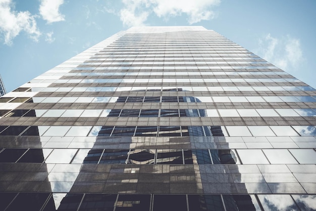 Low angle view of modern building against cloudy sky