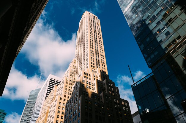 Low angle view of modern buildings against blue sky