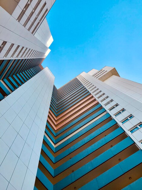 Low angle view of modern buildings against clear blue sky in berlin gropiusstadt