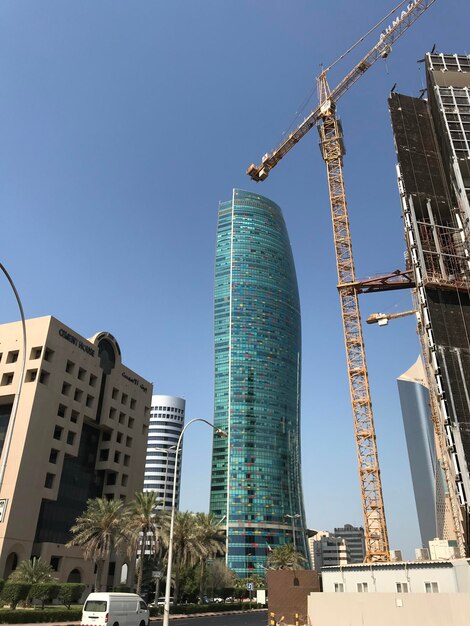 Low angle view of modern buildings against clear blue sky