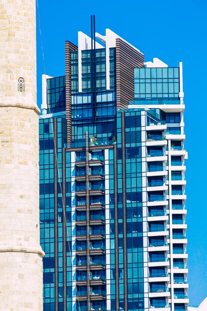 Low angle view of modern buildings against clear blue sky