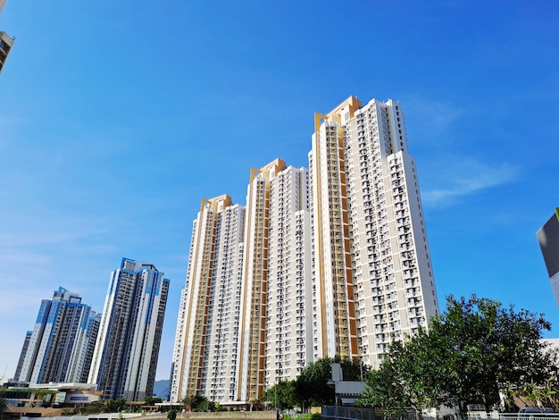 Low angle view of modern buildings against clear blue sky