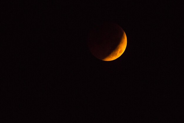 Low angle view of moon against clear sky at night