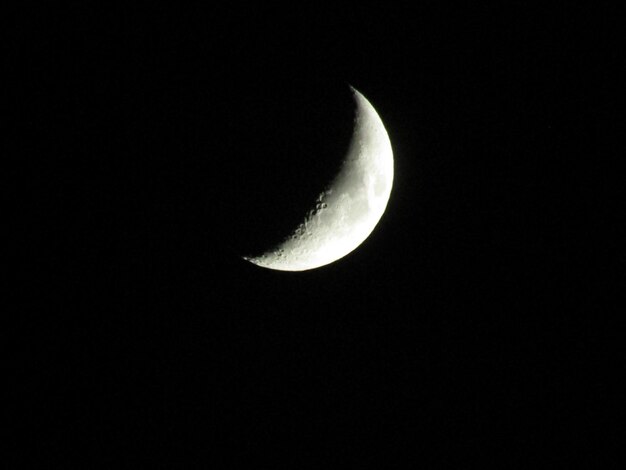 Low angle view of moon against clear sky at night