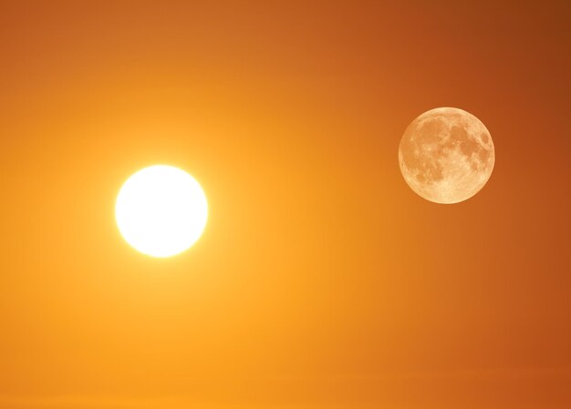 Low angle view of moon against orange sky