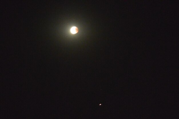 Low angle view of moon against sky at night