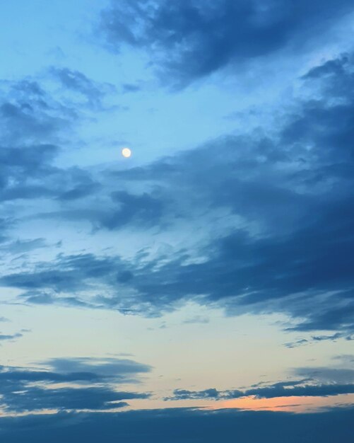 Low angle view of moon at sunset