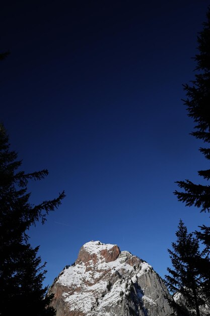 Low angle view of mountain against blue sky