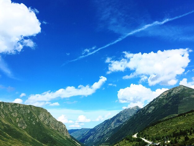 Low angle view of mountain against blue sky