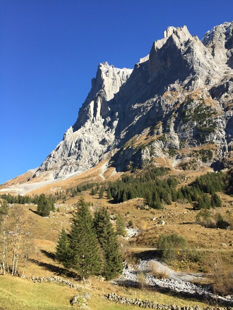 Low angle view of mountain against clear blue sky