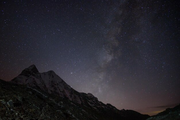 Low angle view of mountain against star field