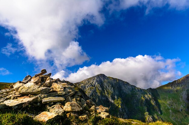 Low angle view of mountain range against blue sky