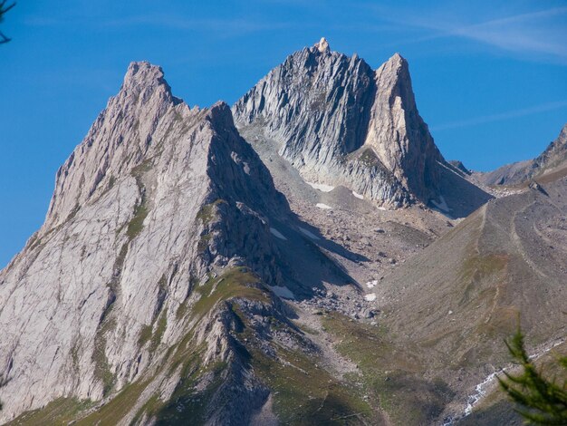 Low angle view of mountains against blue sky