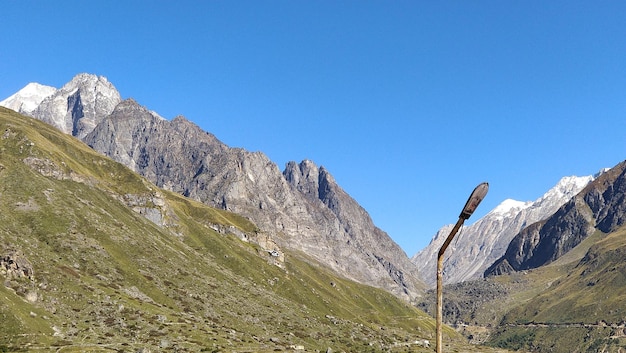 Low angle view of mountains against clear blue sky