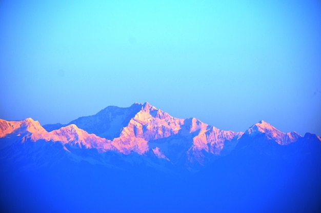 Low angle view of mountains against clear blue sky