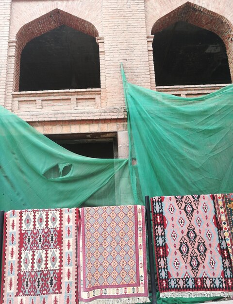 Low angle view of multi colored flags on building