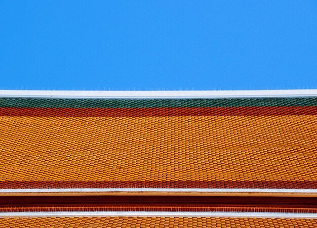 Low angle view of multi colored roof against clear sky