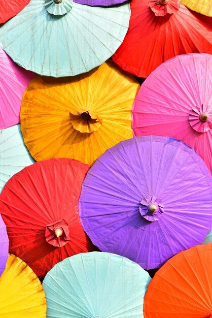 Low angle view of multi colored umbrellas in market