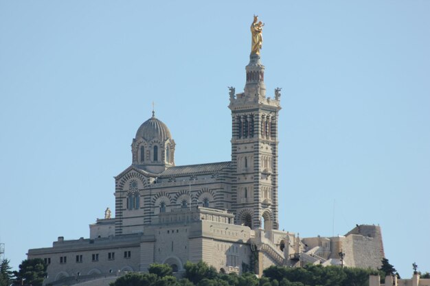 Low angle view of notre-dame de la garde against clear blue sky