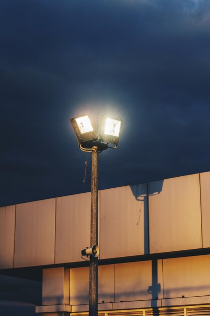 写真 夜の雲の空に照らされたフラッドライトの低角度の視点