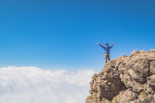 写真 山頂に立っている男の低角度の写真