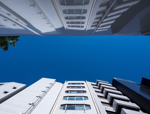 Low angle view of office building against blue sky