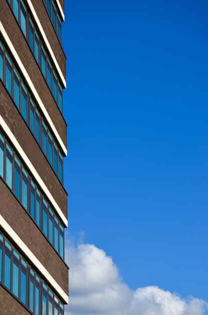 Low angle view of office building against blue sky