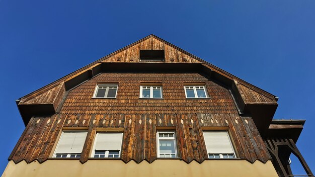 Low angle view of old building against blue sky