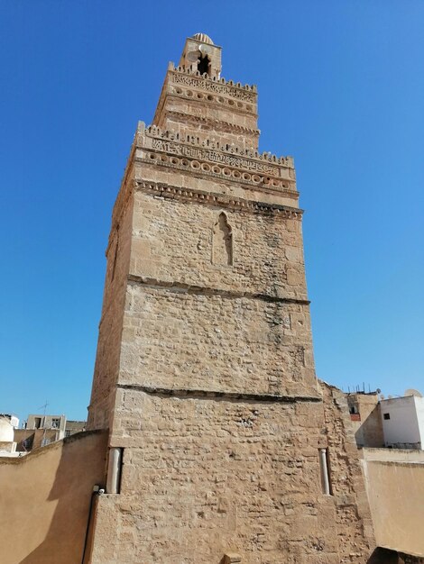 Low angle view of old building against blue sky