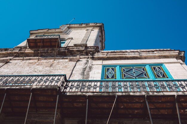 Low angle view of old building against blue sky