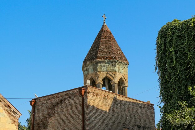 Low angle view of old building against clear blue sky