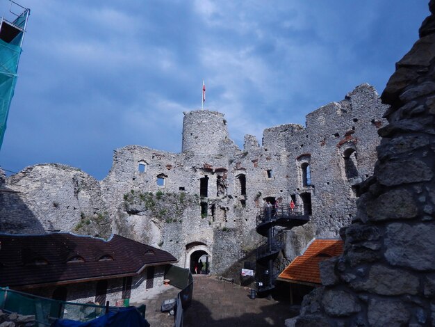 Low angle view of old building against cloudy sky