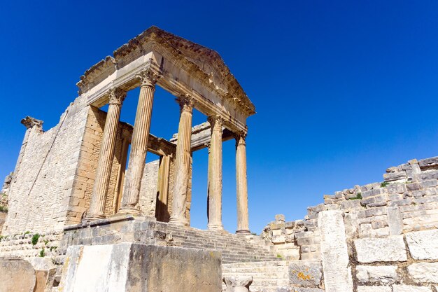 Low angle view of old ruins against blue sky