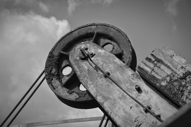 low angle view of old wheel against sky