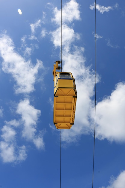 Low angle view of overhead cable car against blue sky