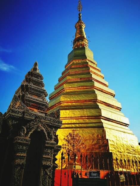 Low angle view of pagoda against blue sky