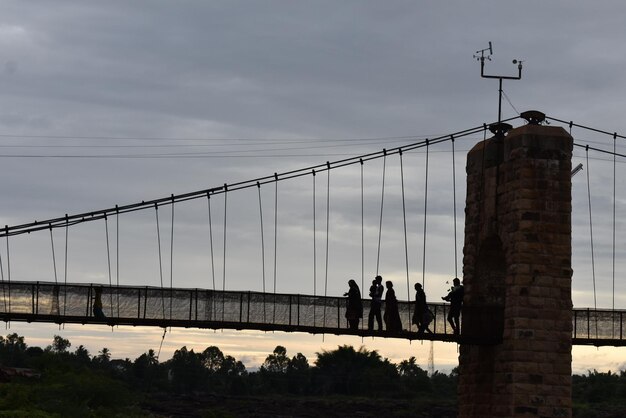 Low angle view of people on bridge