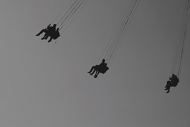low angle view of people on chain swing ride
