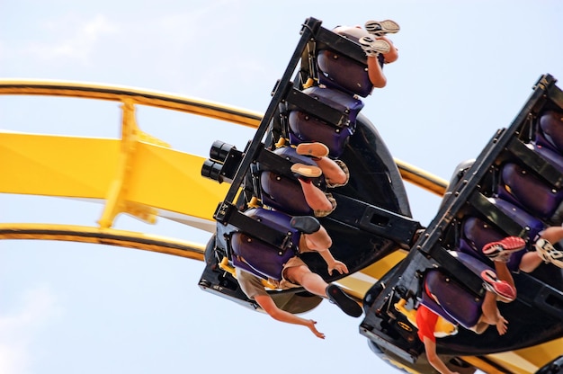 low angle view of people enjoying roller coaster ride