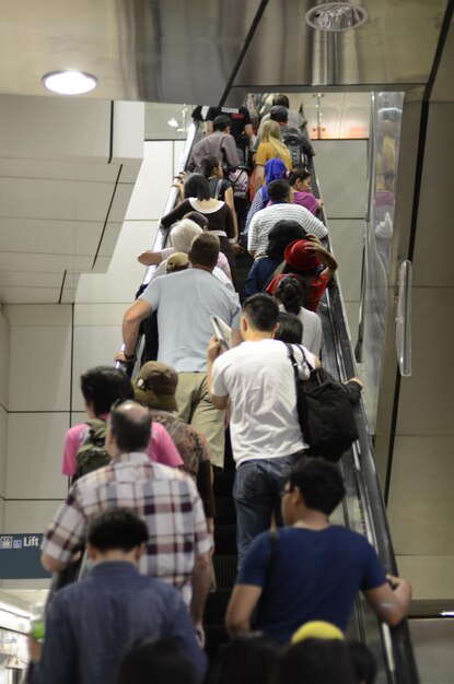 Photo low angle view of people on escalator in subway