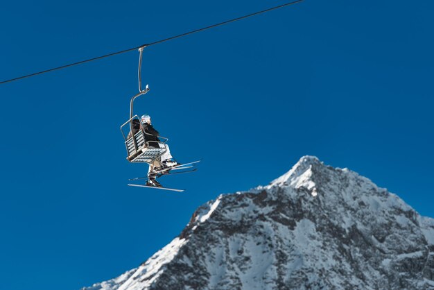 Low angle view of people sitting on cable car