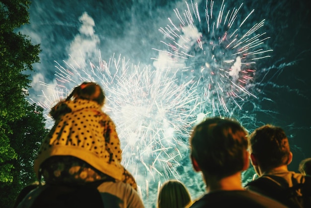 low angle view of people watching firework display