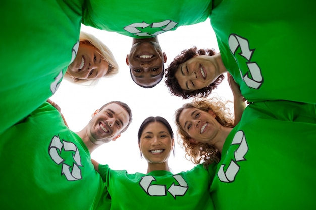 Low angle view of people wearing green shirt with recycling symbol on it
