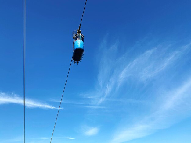 Low angle view of person paragliding against sky