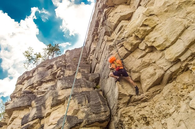 Foto vista a bassa angolazione di una persona sulla roccia contro il cielo