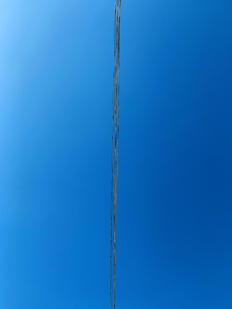 Low angle view of pole against clear blue sky