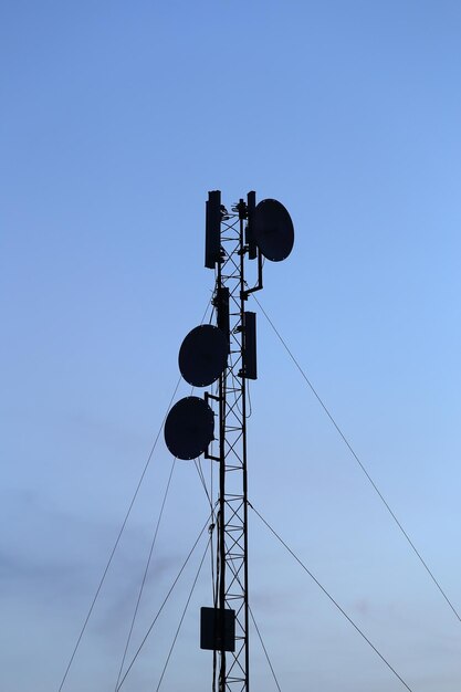 Low angle view of power lines against blue sky