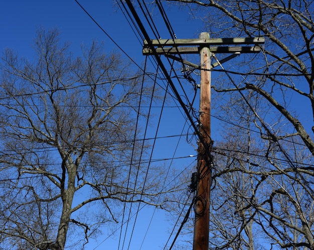 Low angle view of power lines against clear blue sky